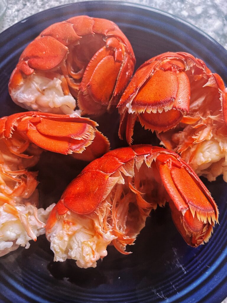 four cooked lobster tails