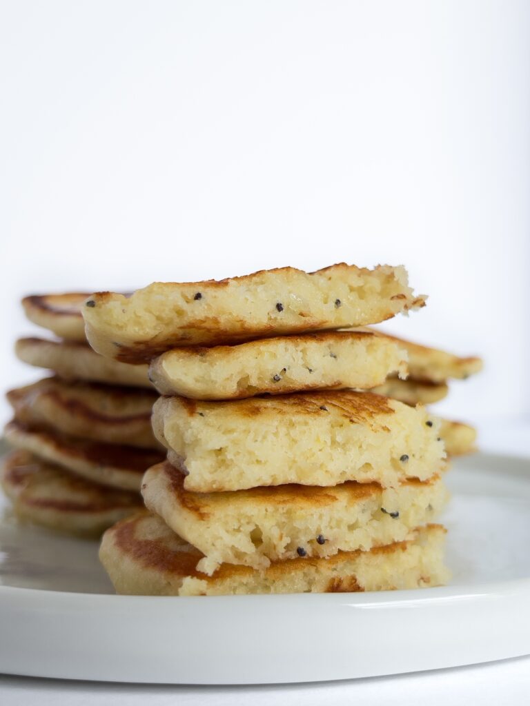 a cut stack of lemon poppyseed pancakes